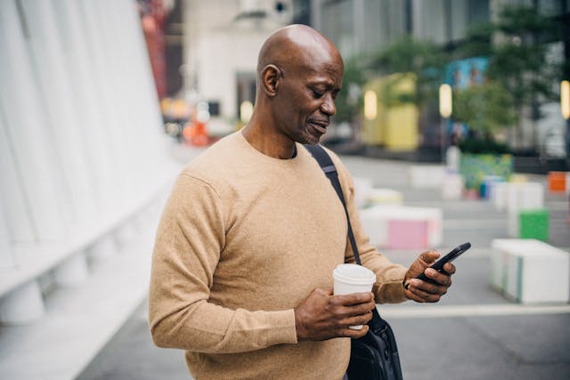 Man using mobile phone in city